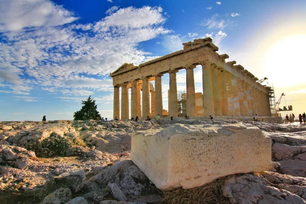 people visiting the parthenon at sunset